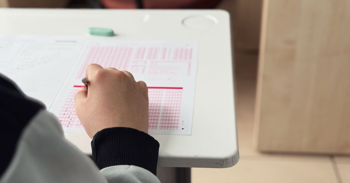 Two academics reviewing documents together at a university meeting